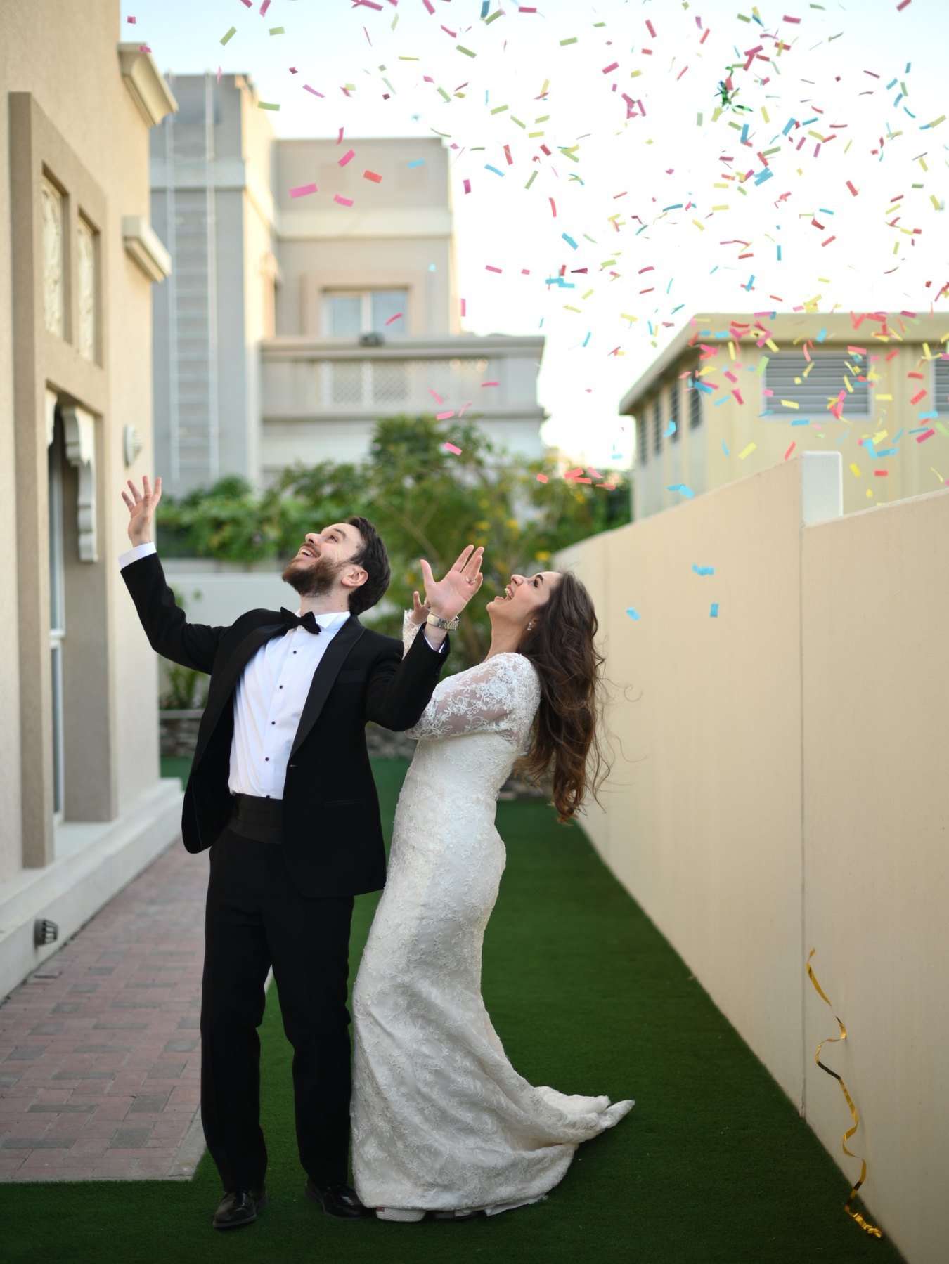 Bride with parasol and groom in soft afternoon light